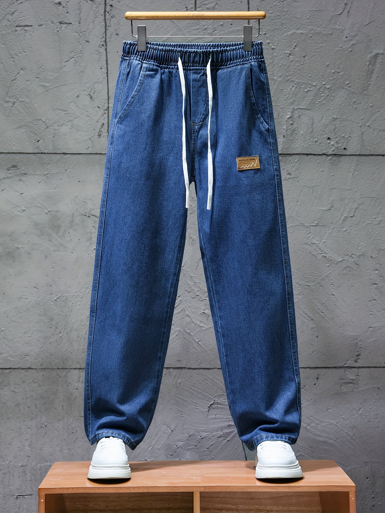 Dark blue jeans with an elastic waistband and drawstring