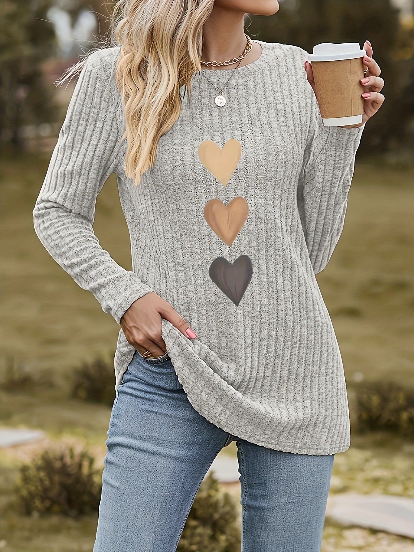 Women's black long-sleeve shirt with heart appliqués