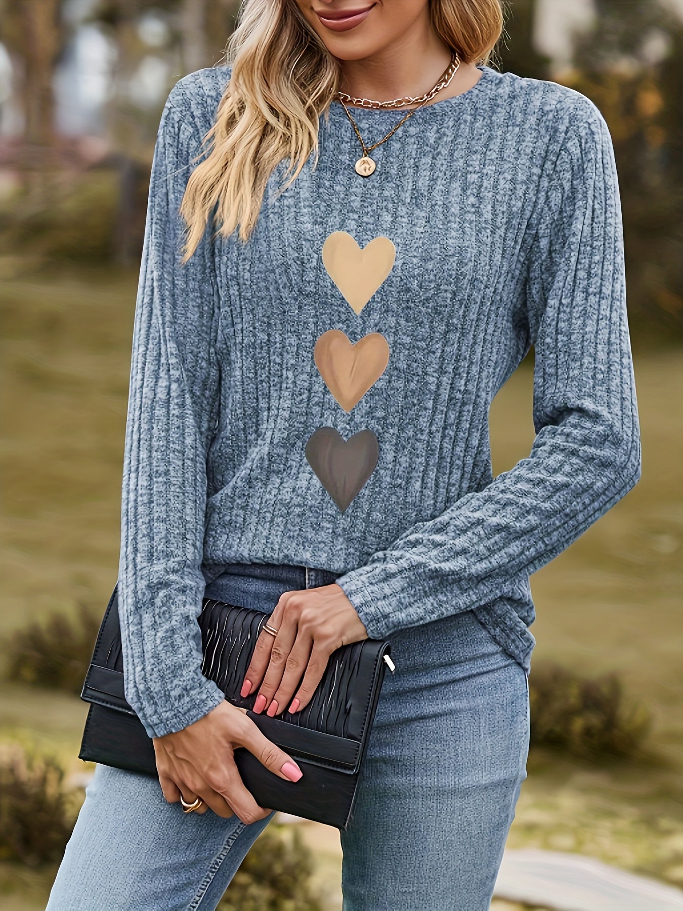 Women's black long-sleeve shirt with heart appliqués
