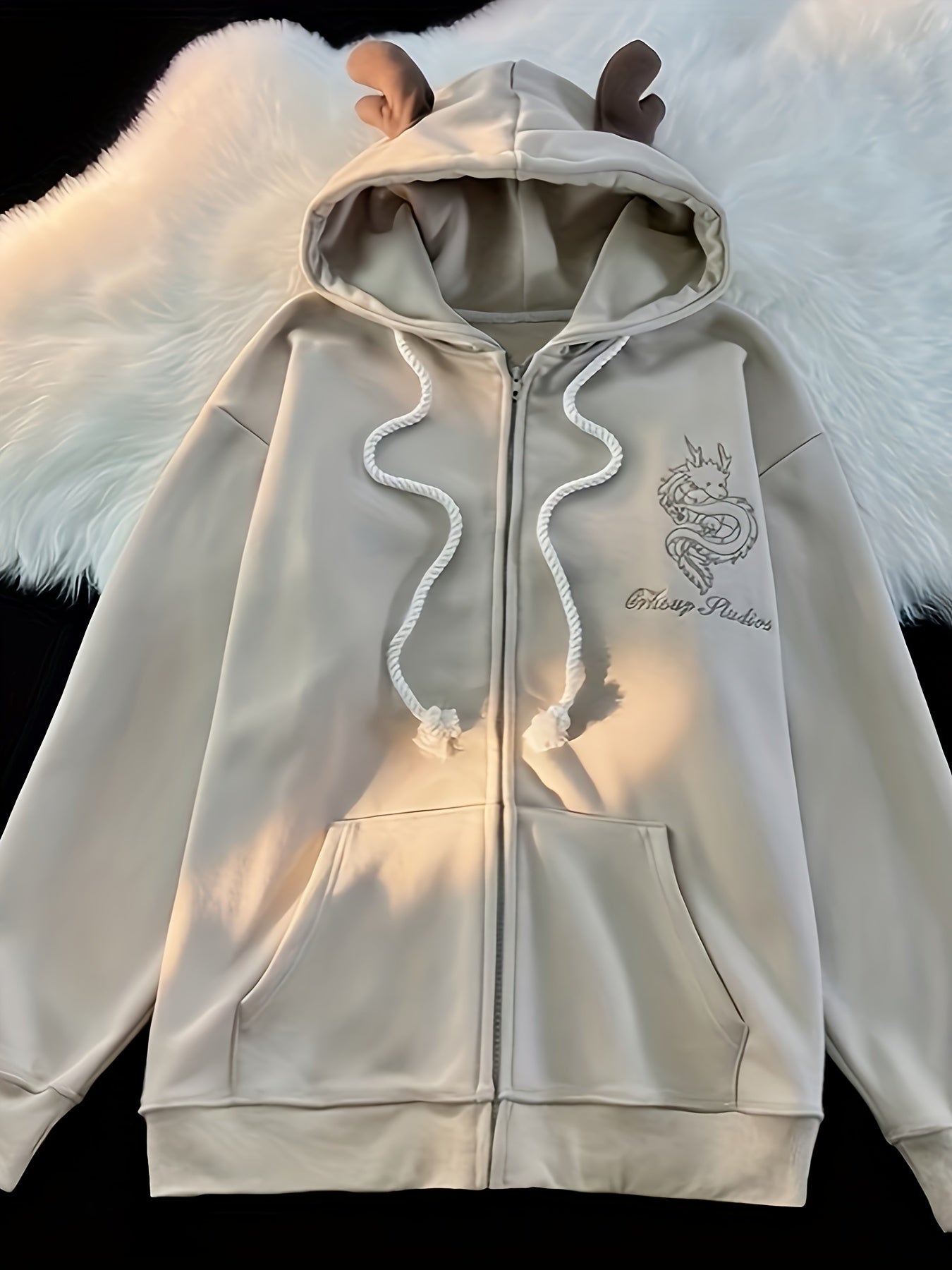 Beige zip-up hoodie with dragon embroidery and antler hood