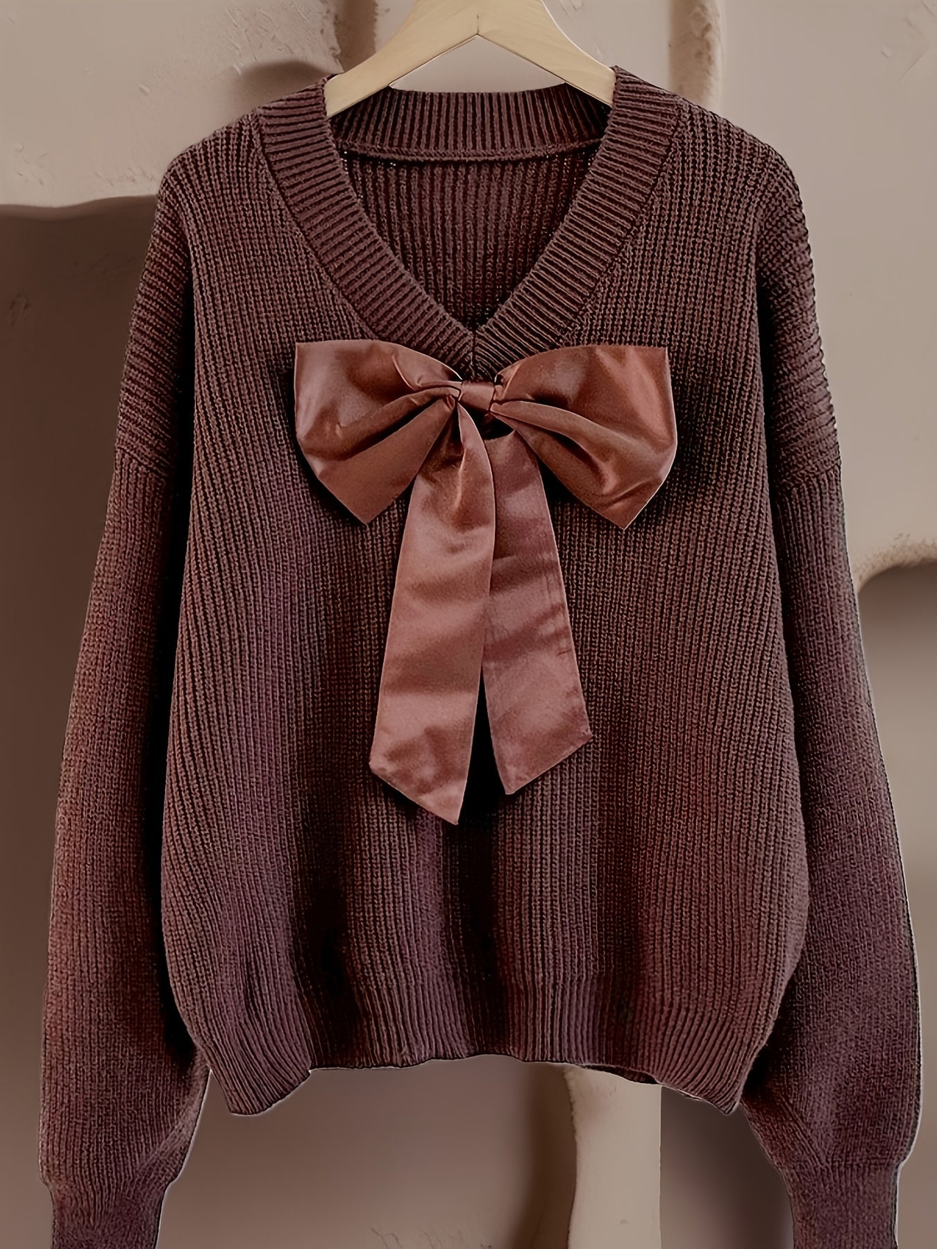 Women's ribbed long-sleeve V-neck sweater with a large bow