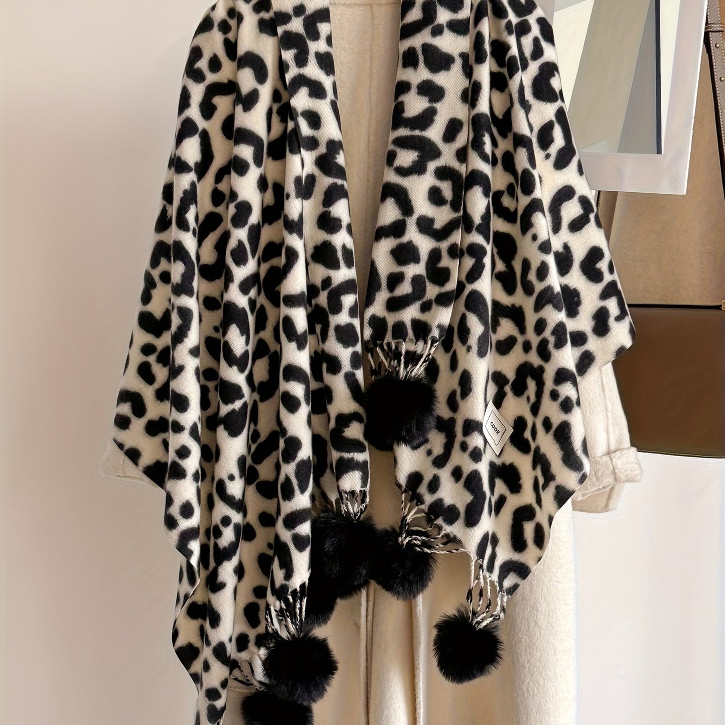 Leopard-print scarf with pom-poms