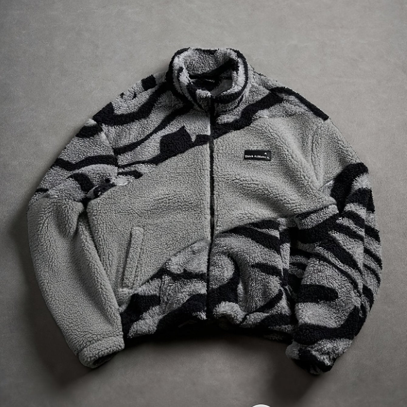 Unisex fleece jacket with stand-up collar, zipper, and animal print