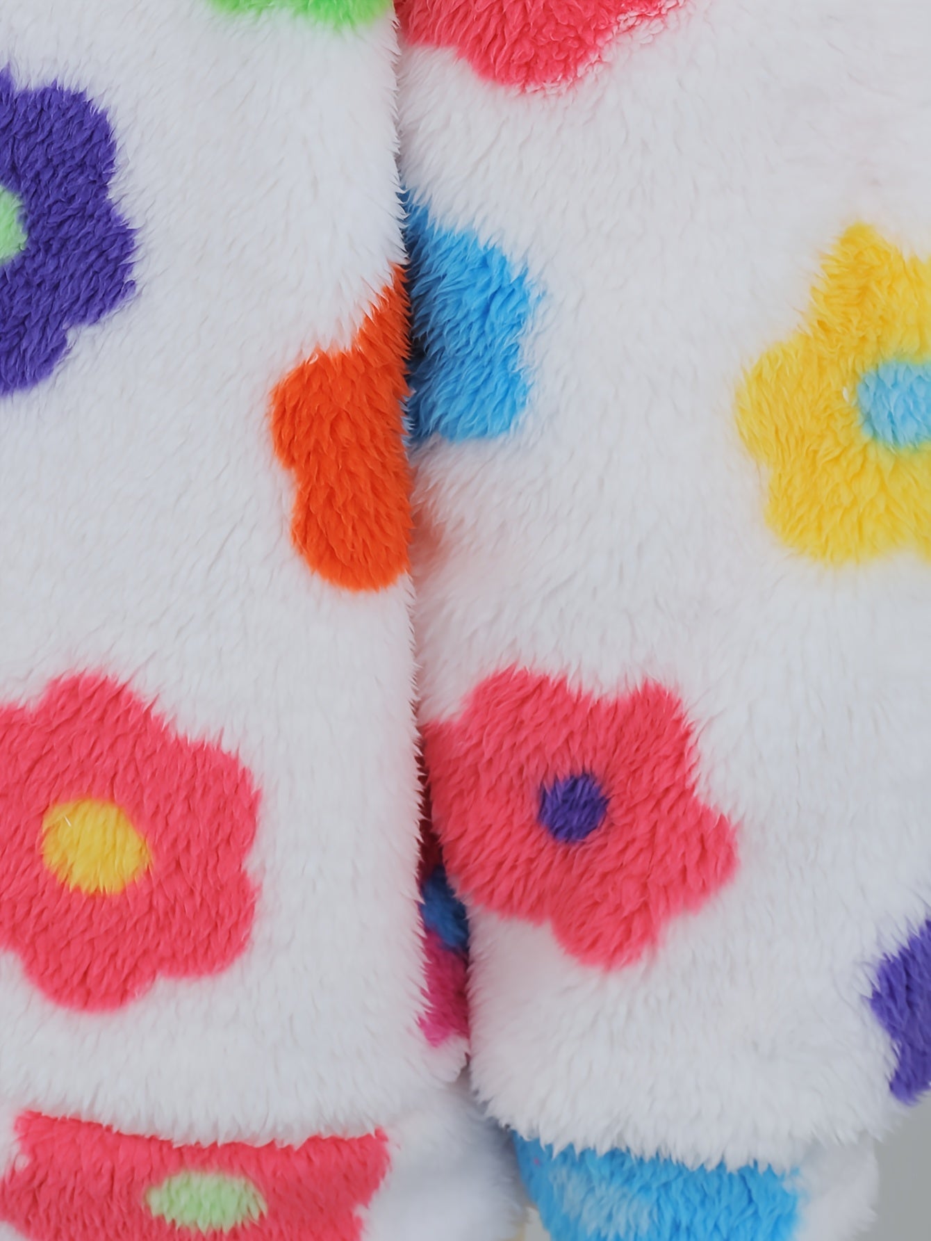 Hooded teddy jacket with colorful floral patterns and a zipper