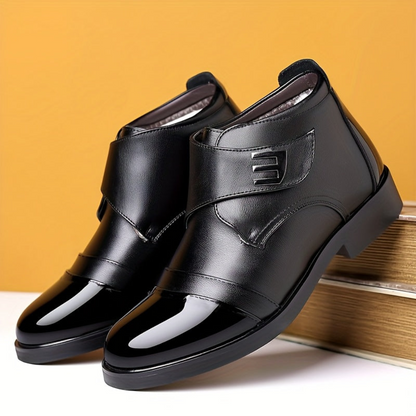 Black men’s slip-on ankle boots with a polished toe cap and Velcro fastening