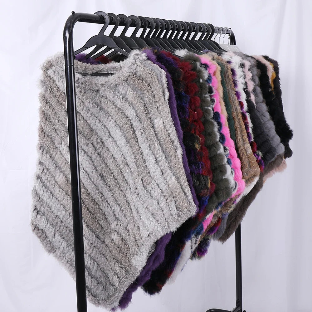 Soft faux-fur-look poncho with short sleeves, a round neckline, and an asymmetrical hem