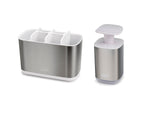 Tandenborstelhouder met witte vakken en zeepdispenser met pomp, beide in RVS met wit, op witte achtergrond