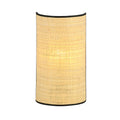 Halfronde wandlamp met naturel rotan kap en zwarte rand, verlicht en van voren gezien