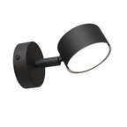 Zwarte wandlamp met ronde wandplaat, korte arm en ronde lampenkop met verlichte onderzijde