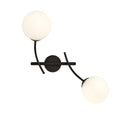 Zwarte wandlamp met twee witte glazen bollen aan gebogen stalen armen en een ronde wandplaat