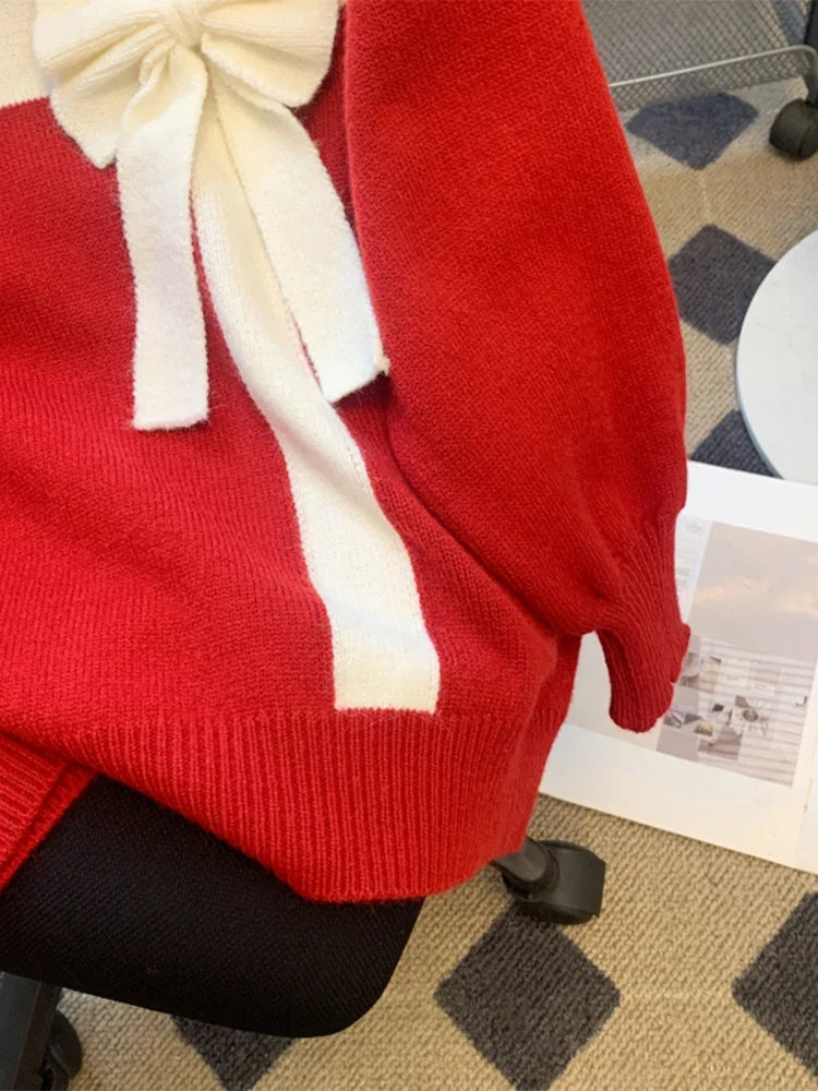 Red sweater with white bow detail and crew neckline