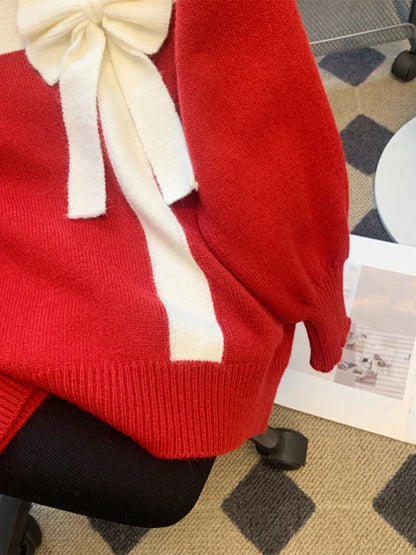 Red sweater with white bow detail and crew neckline