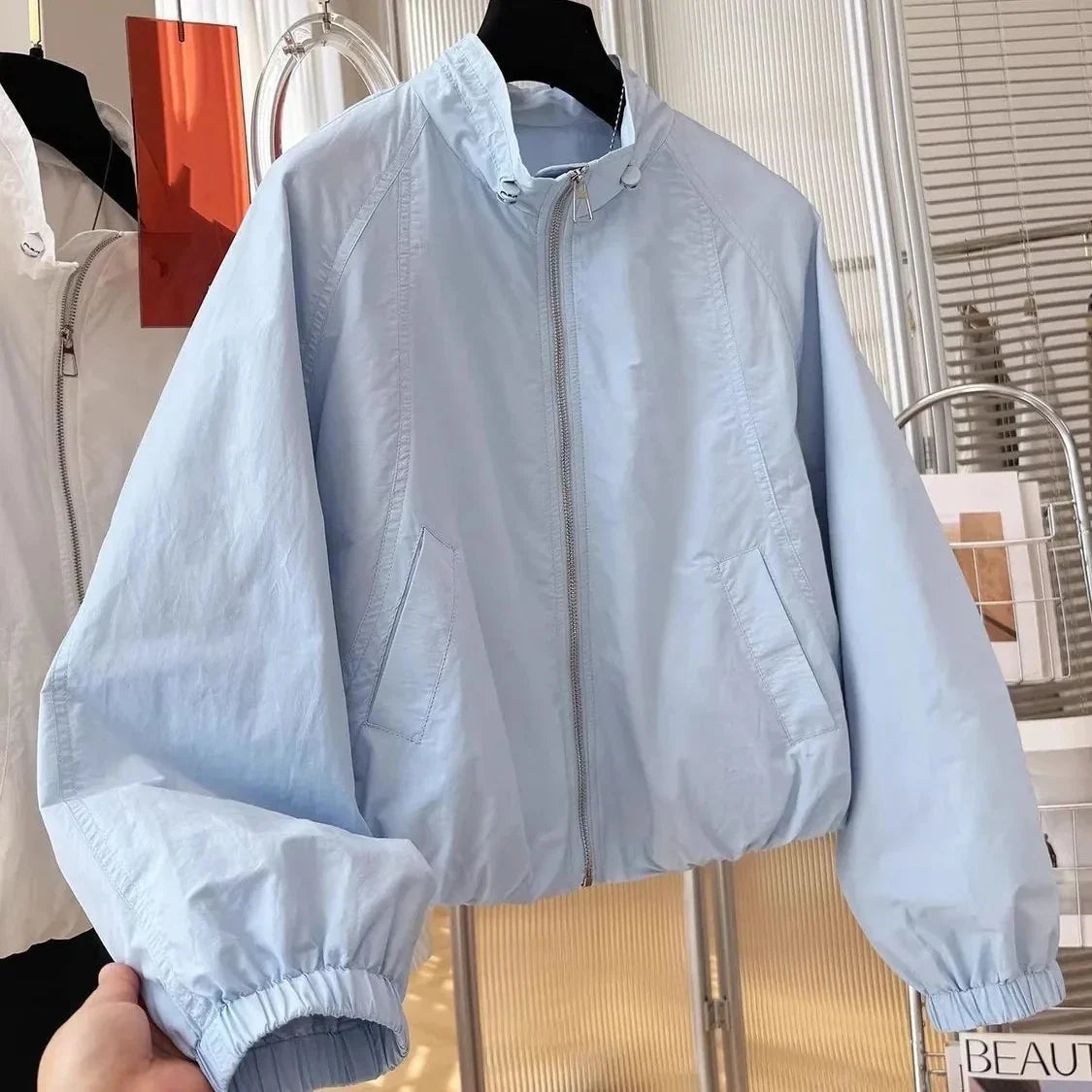 Women's lightweight short bomber jacket with stand-up collar, light blue