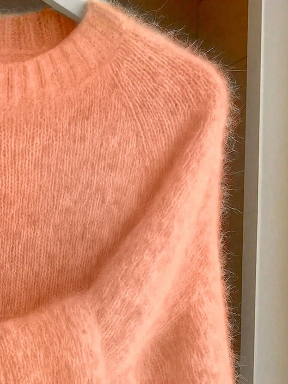 Women's coral sweater with crew neckline