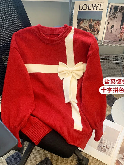 Red sweater with white bow detail and crew neckline