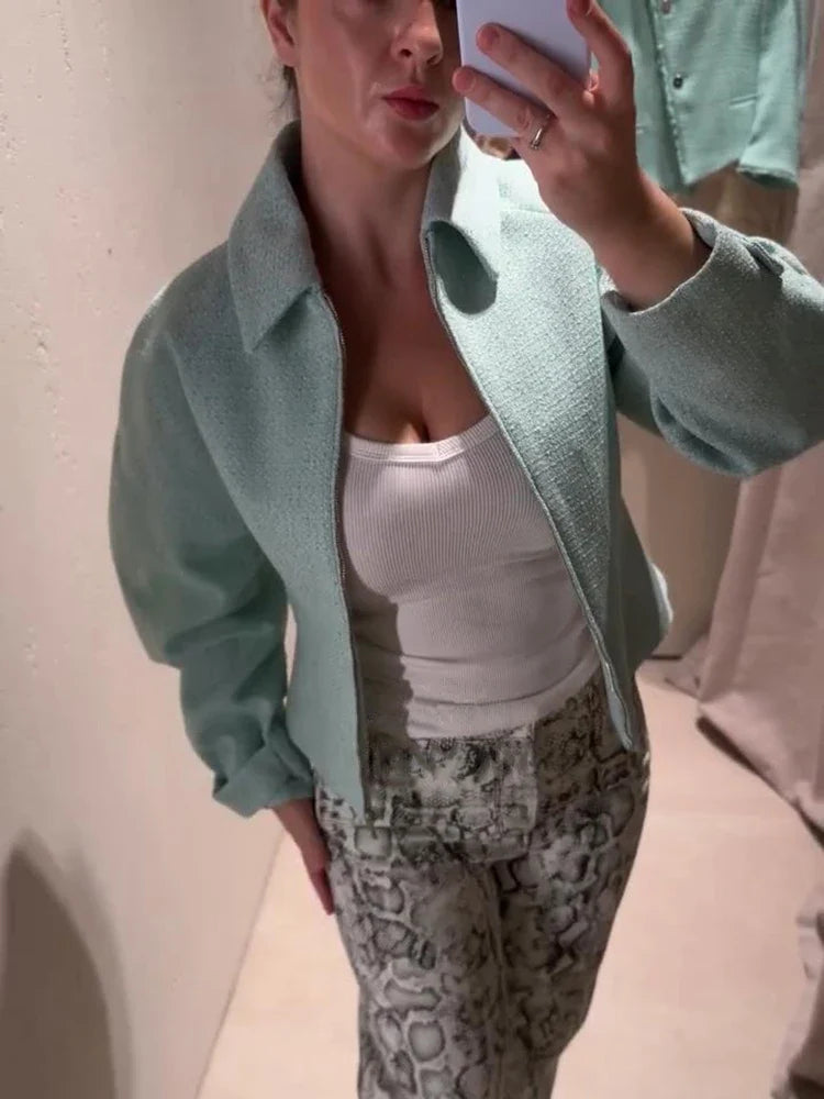 Women's mint green short jacket with zipper, collar, and textured material