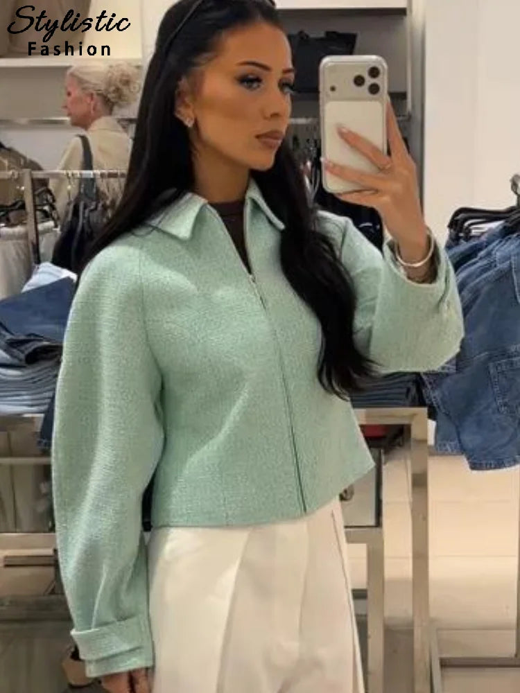 Women's mint green short jacket with zipper, collar, and textured material