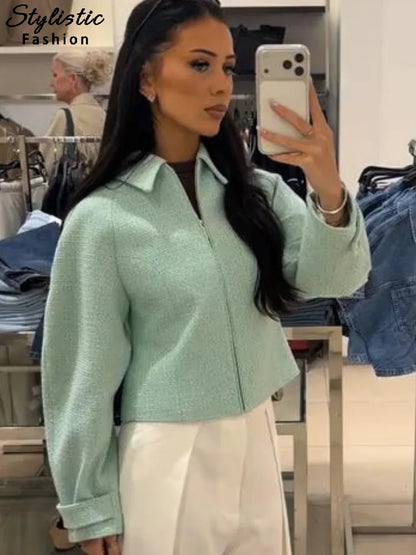 Women's mint green short jacket with zipper, collar, and textured material