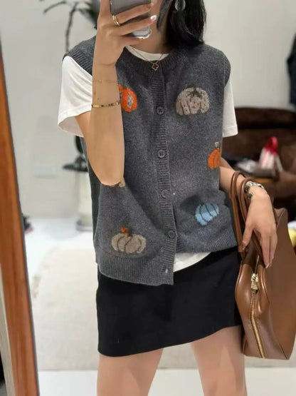 Women's knitted vest with pumpkin motifs, button placket, and round neckline