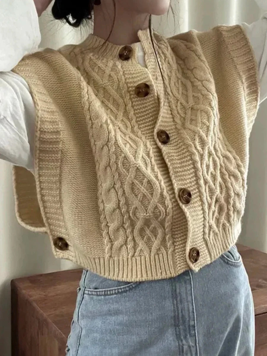 Women's cropped sleeveless cardigan with cable knit pattern, crew neck, and button placket