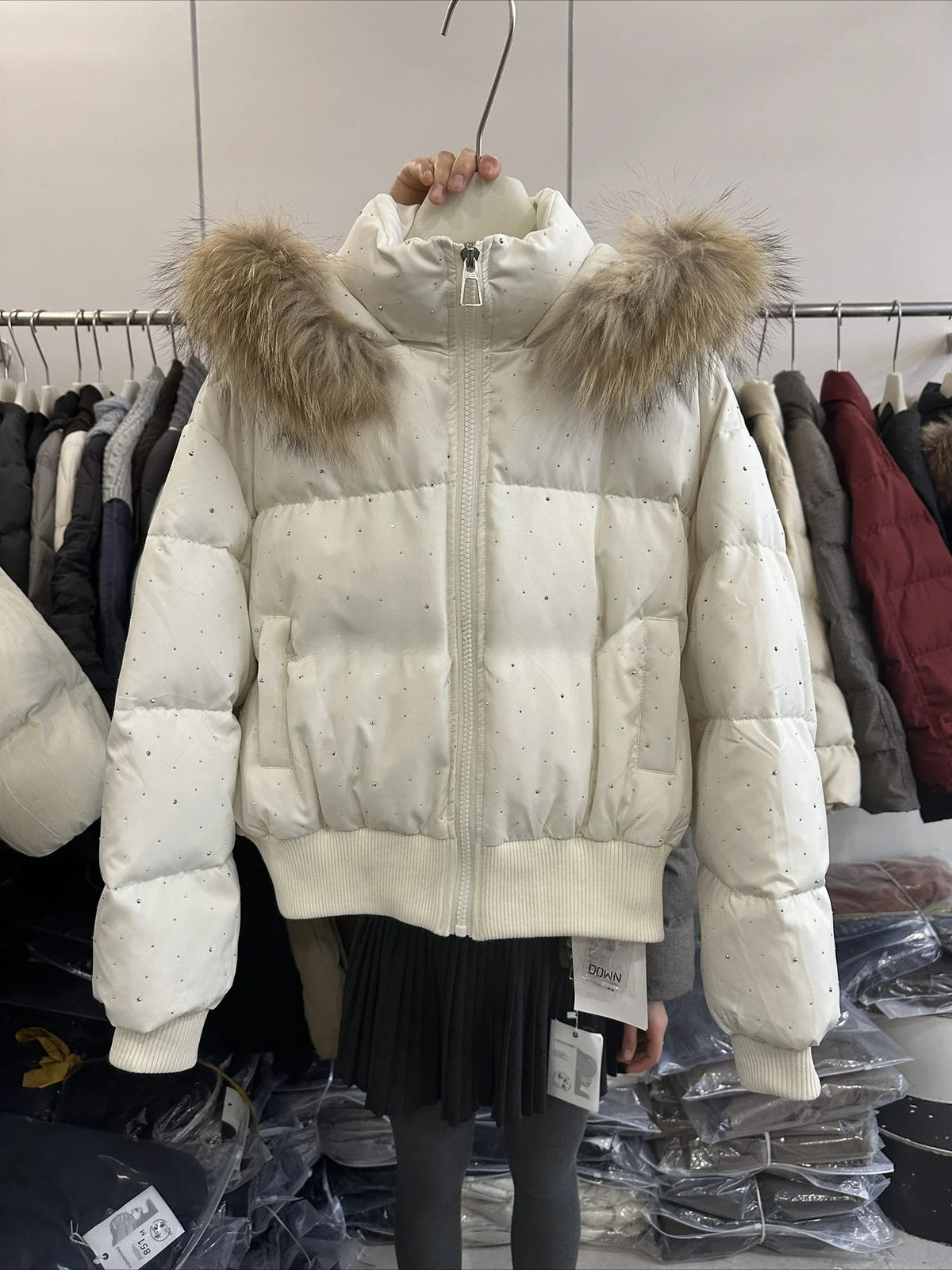 Women's quilted jacket with faux-fur hood and glitter details