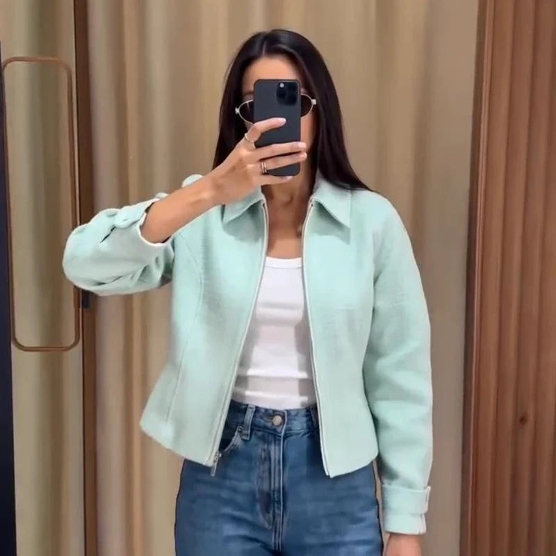 Women's mint green short jacket with zipper, collar, and textured material