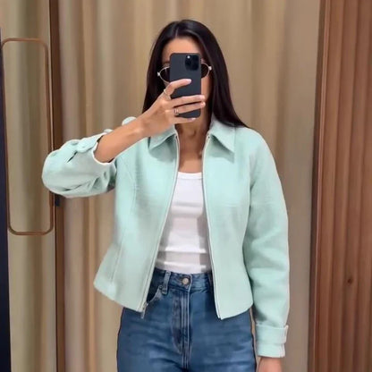 Women's mint green short jacket with zipper, collar, and textured material