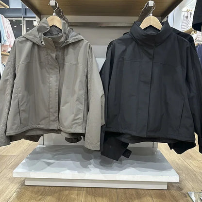 Short women's transitional jacket with hood and stand-up collar