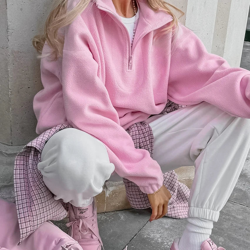 Women's pink fleece pullover with zip-up stand collar and long sleeves