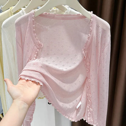 Pink women's cropped knitted cardigan with open-knit pattern, ruffled hem, summer cardigan