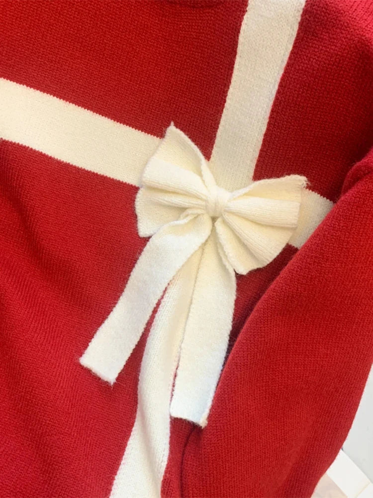 Red sweater with white bow detail and crew neckline