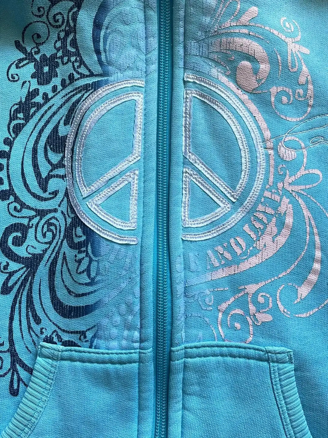 Women's turquoise hoodie with zipper and graphic print