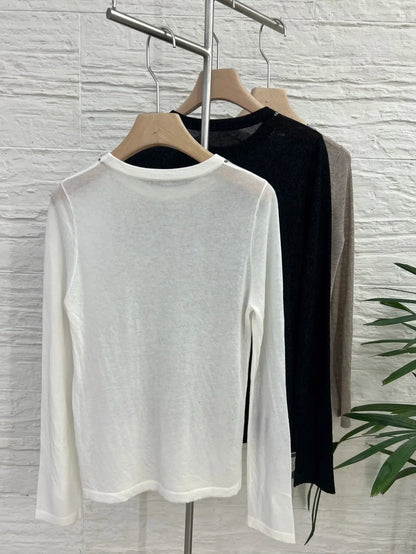 Crew-neck long-sleeve top with contrast stitching, slightly sheer fabric