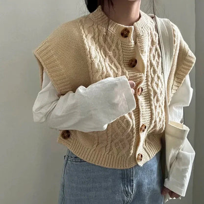 Women's cropped sleeveless cardigan with cable knit pattern, crew neck, and button placket