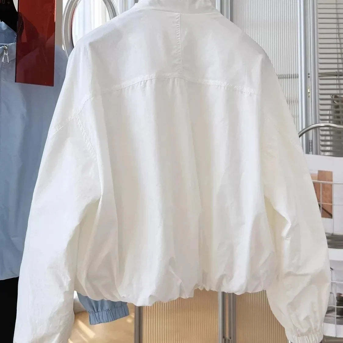 Women's lightweight short bomber jacket with stand-up collar, light blue