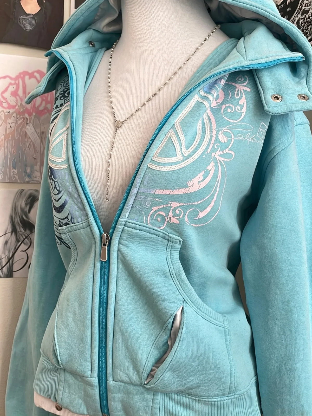 Women's turquoise hoodie with zipper and graphic print