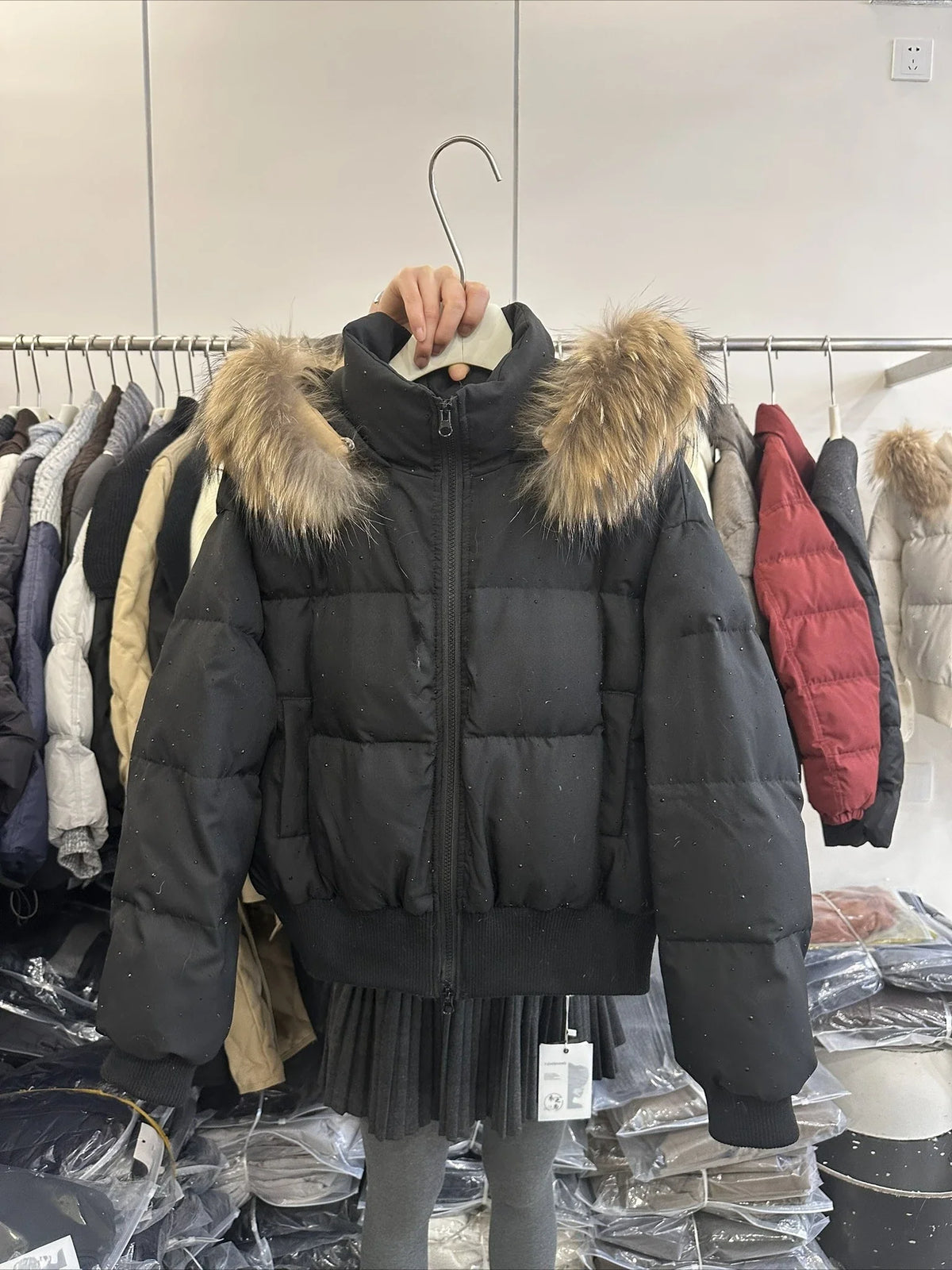 Women's quilted jacket with faux-fur hood and glitter details