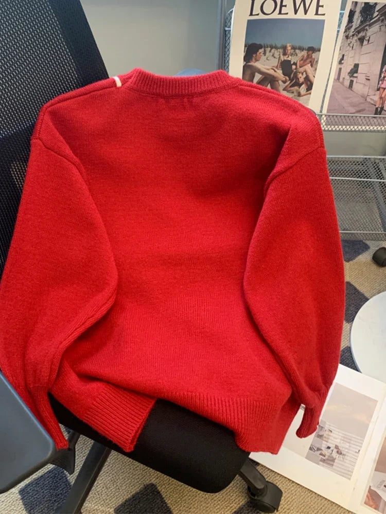 Red sweater with white bow detail and crew neckline
