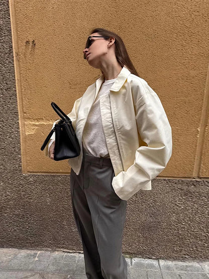 Women's cream-colored jacket with zipper, collar, and wide sleeves