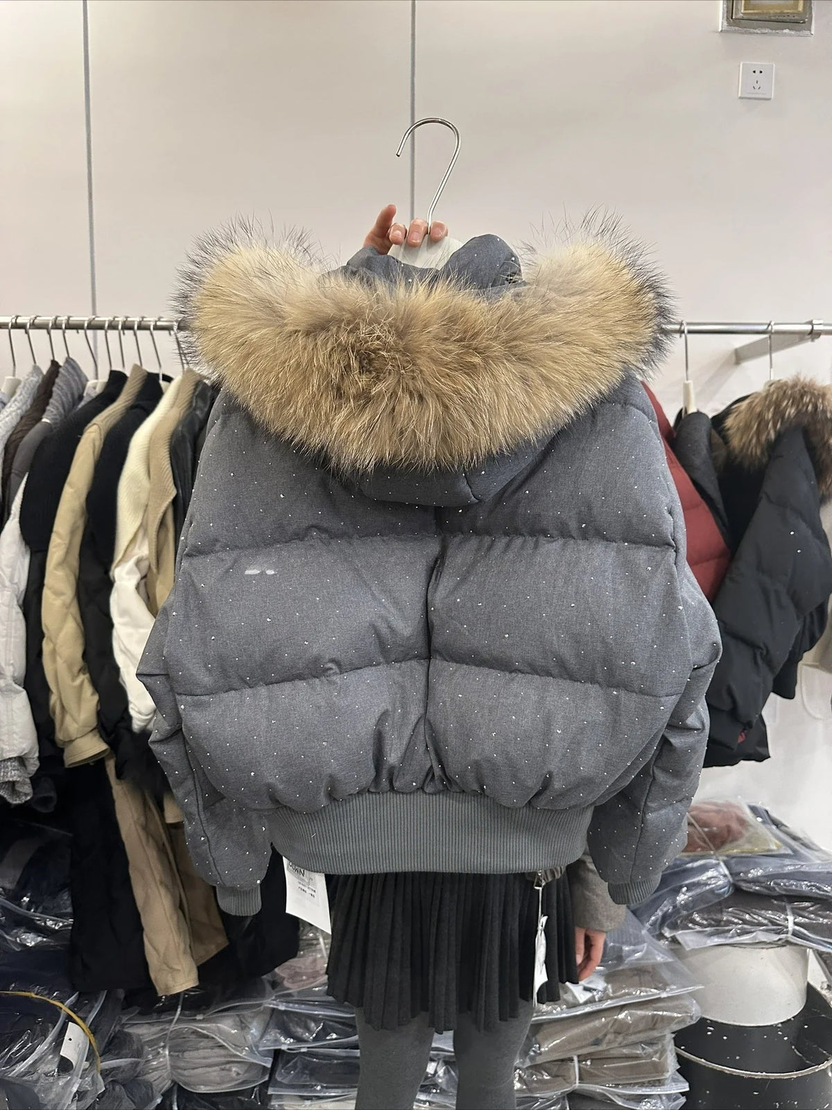 Women's quilted jacket with faux-fur hood and glitter details