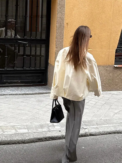 Women's cream-colored jacket with zipper, collar, and wide sleeves