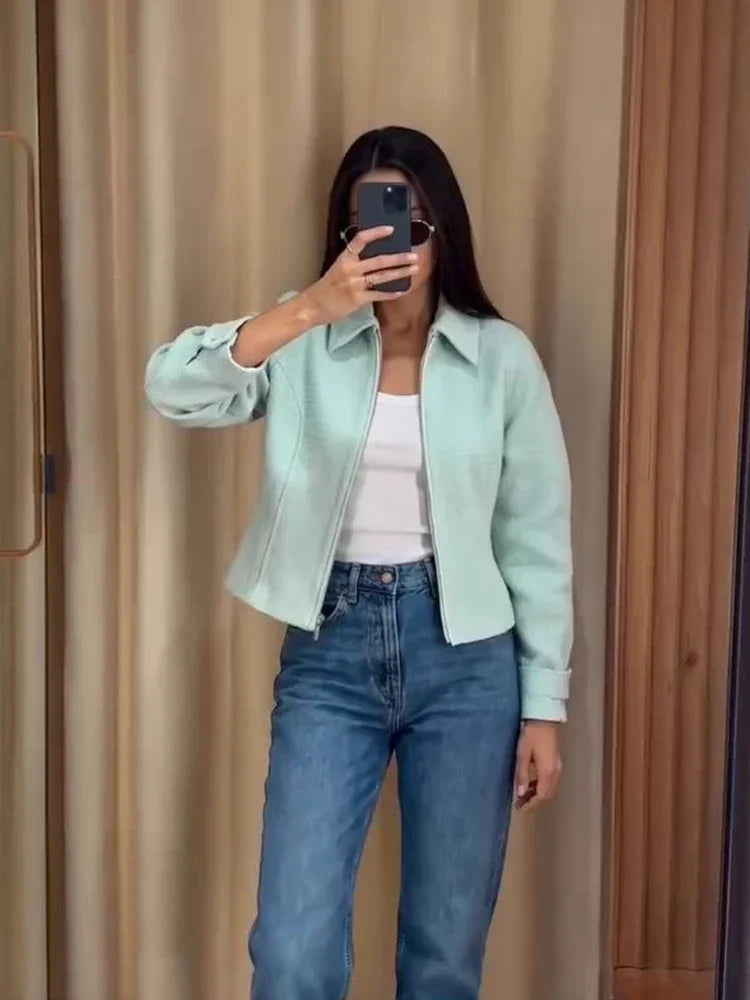 Women's mint green short jacket with zipper, collar, and textured material