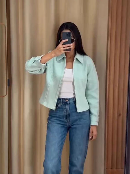 Women's mint green short jacket with zipper, collar, and textured material