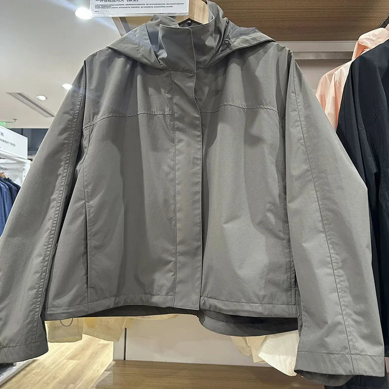 Short women's transitional jacket with hood and stand-up collar