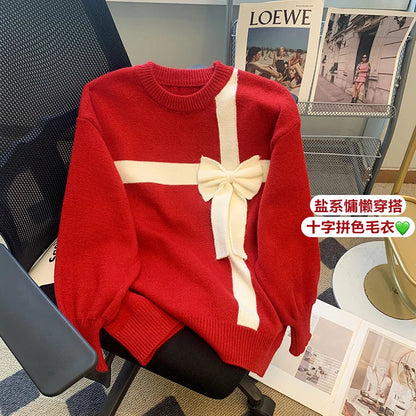 Red sweater with white bow detail and crew neckline