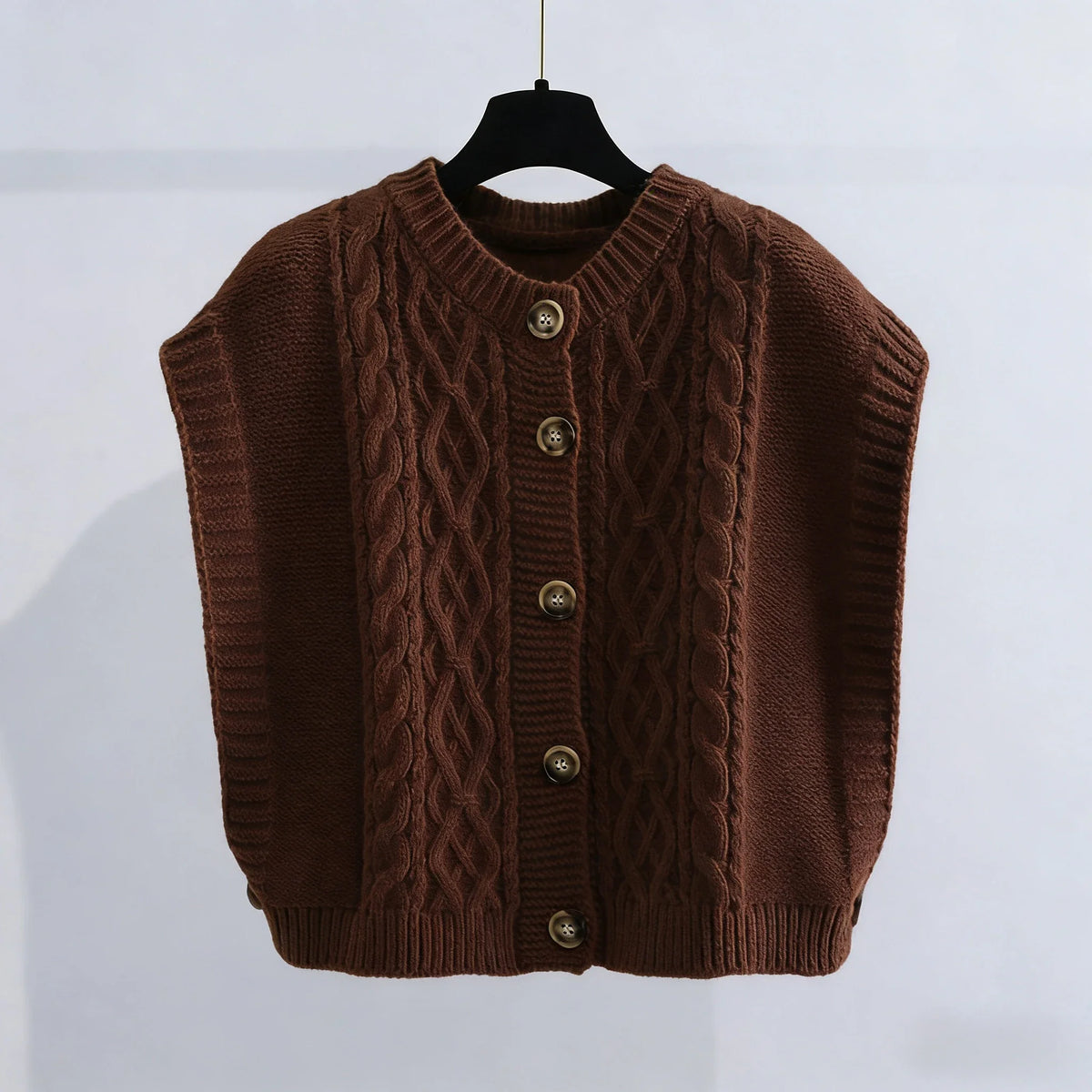 Women's cropped sleeveless cardigan with cable knit pattern, crew neck, and button placket