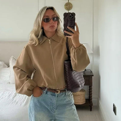 Short women's bomber jacket with collar, zipper, and long sleeves