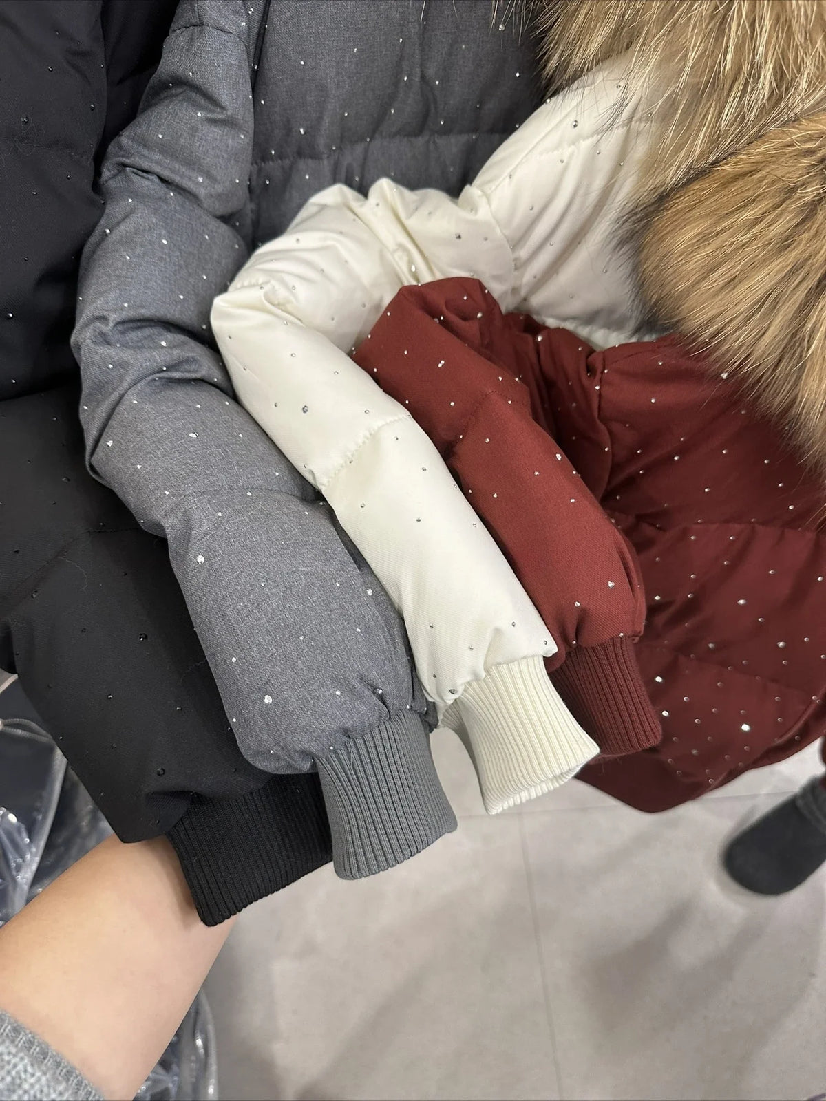 Women's quilted jacket with faux-fur hood and glitter details