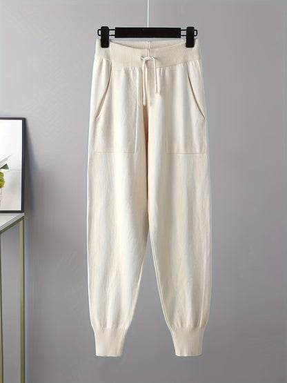 Two-piece women’s knitted set with a V-neck sweater and jogger pants in a beige ribbed-knit design