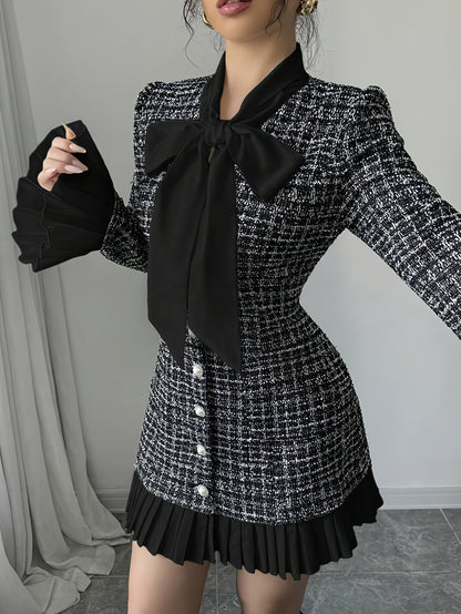 Black-and-white checked dress with a bow and pleated details